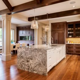 A kitchen with wood floors and white cabinets.
