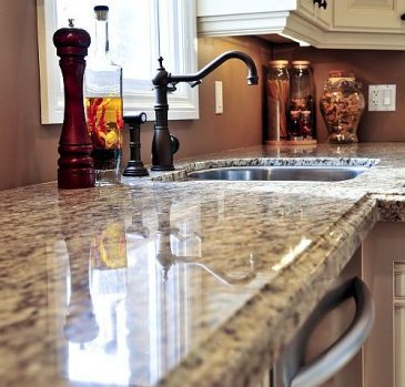 A kitchen with granite counter tops and an island.