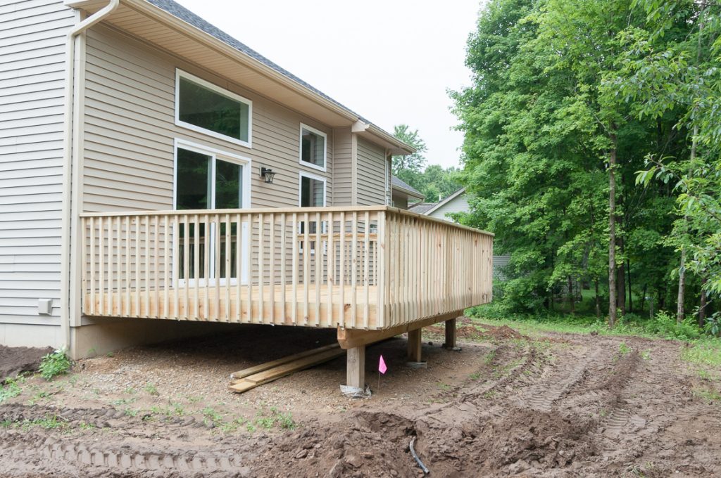 A house with a deck and a dirt path