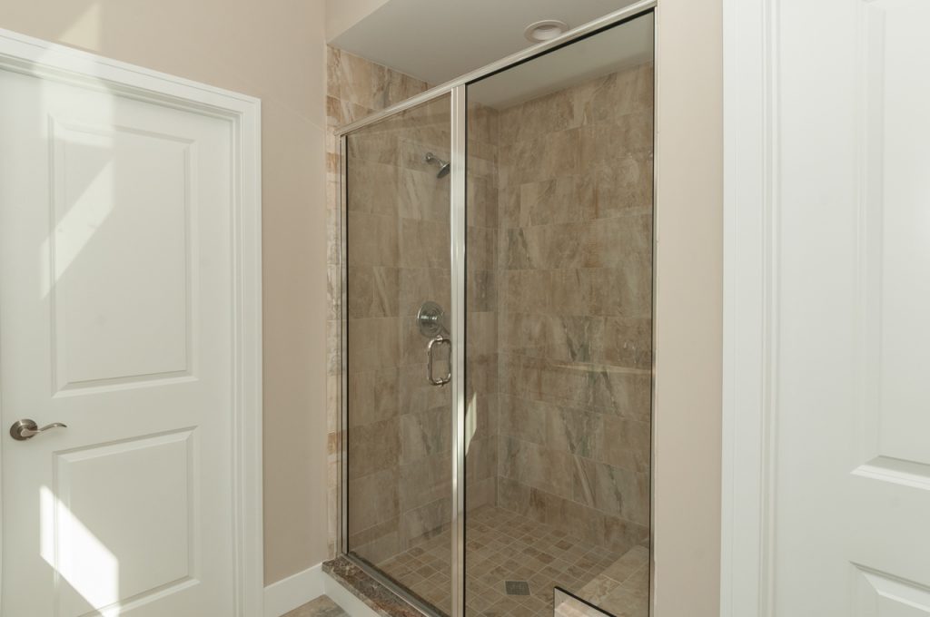 A bathroom with two walk in shower stalls.