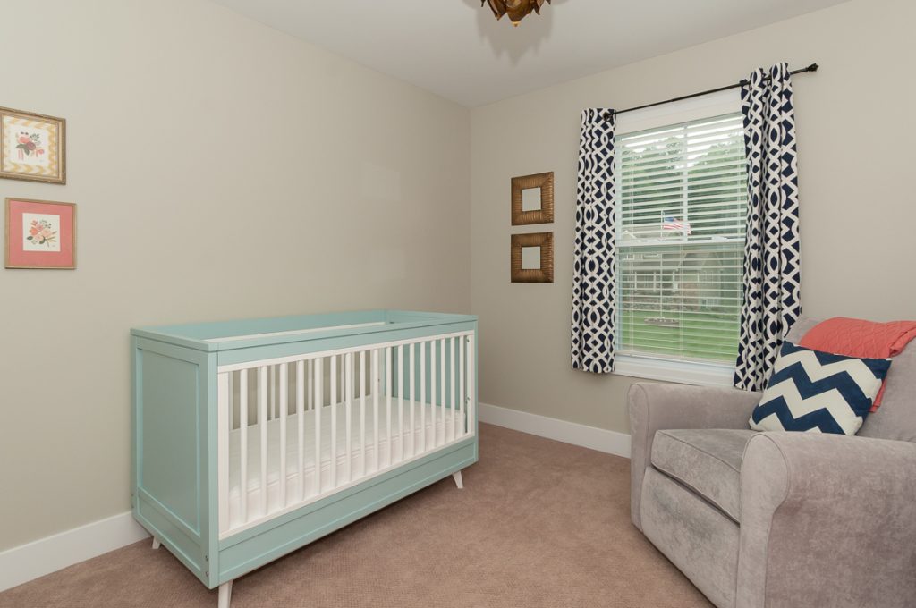 A baby room with a crib and couch