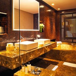 A bathroom with two sinks and a large mirror