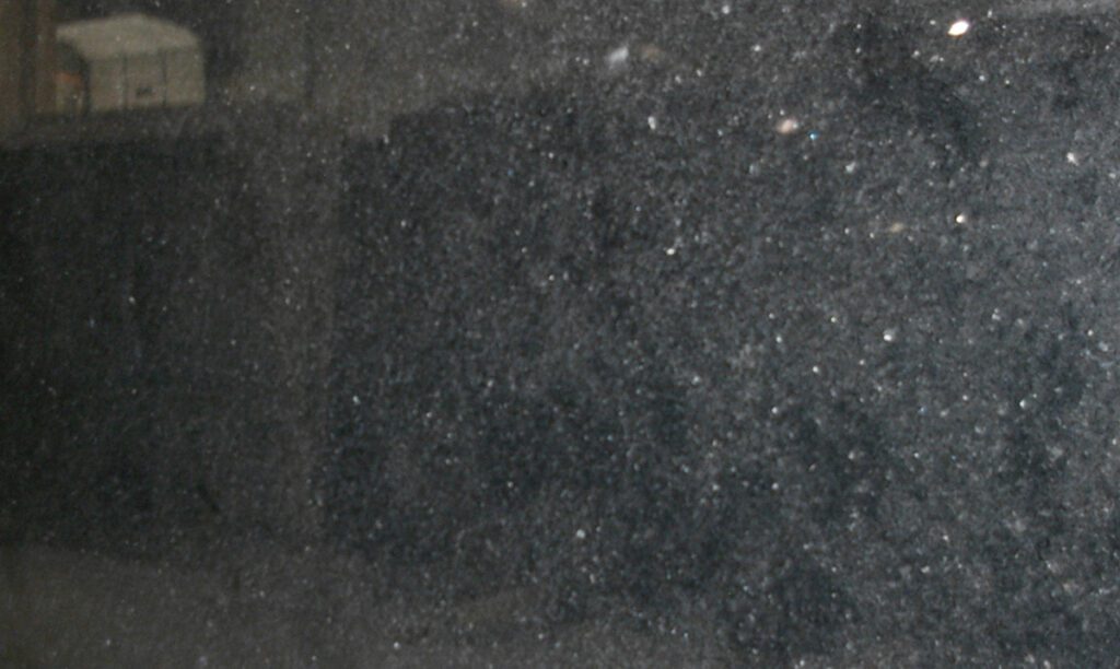 A black substance that is on the ground.