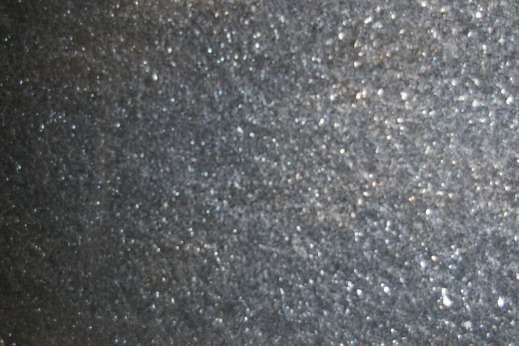 A close up of the black and silver speckled surface.