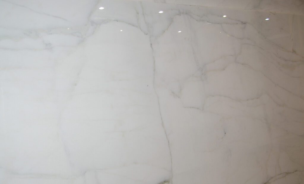 A white marble wall with some lights on it