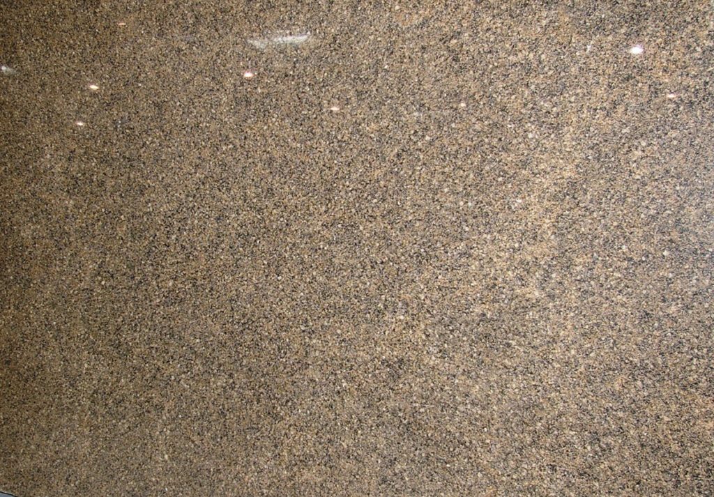 A close up of the surface of a brown granite slab.