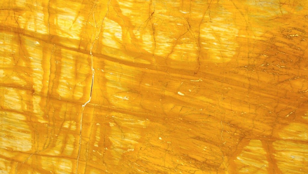 A close up of the yellow surface of a rock