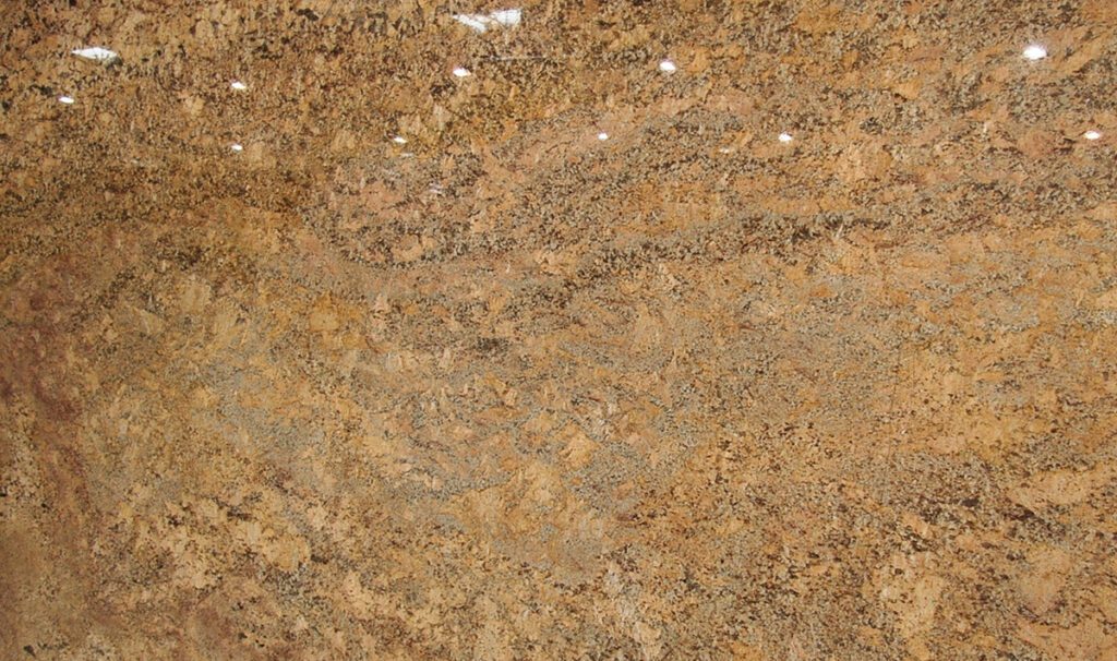 A close up of the surface of a brown granite slab.