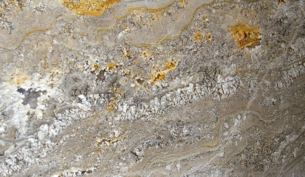 A close up of the rock surface with yellow and white paint.