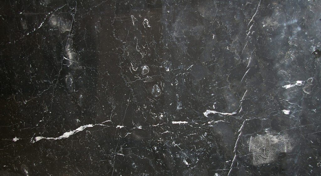 A black marble surface with some white lines
