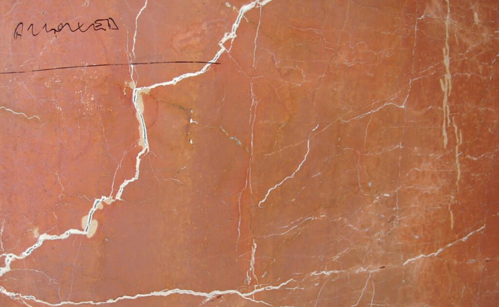 A close up of the marble surface with scratches.