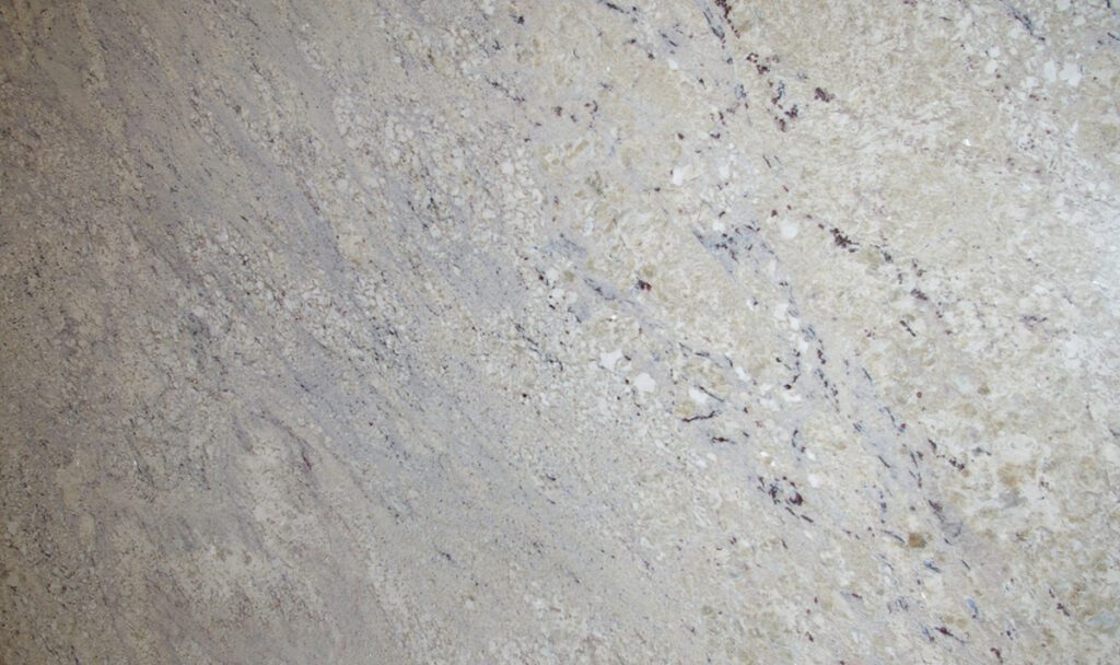 A close up of the surface of a white granite slab.