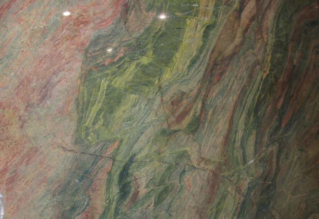 A close up of the green and red marble