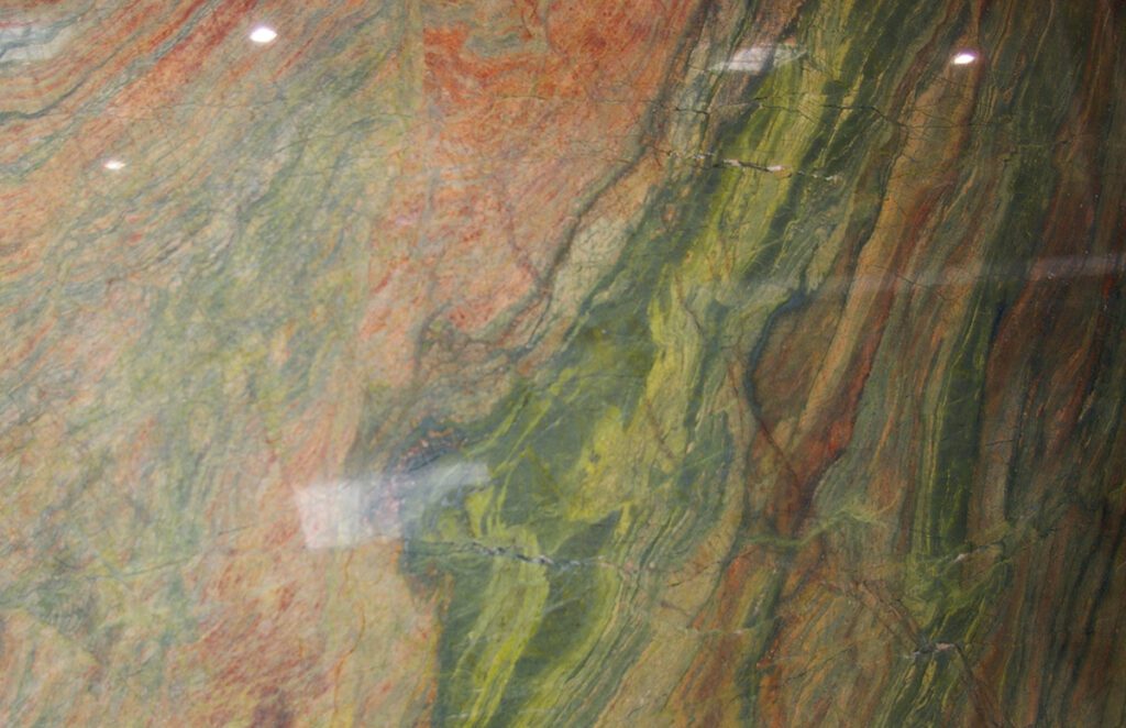 A close up of the green and red marble